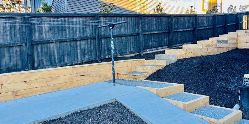 Timber sleeper retaining wall with steps built by SK Civil & Landscaping in Canterbury