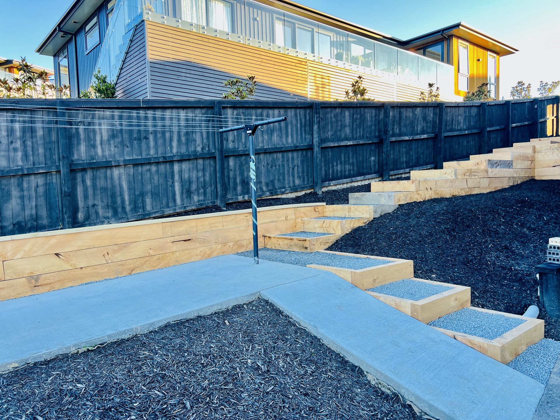 Timber sleeper retaining wall with steps built by SK Civil & Landscaping in Canterbury