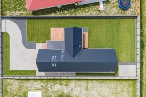 Aerial view of a new build with fresh artificial turf and landscaping, Canterbury