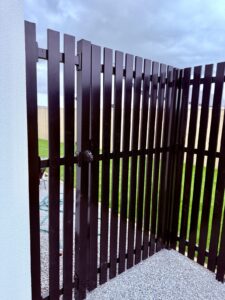 Black slat gate on a new-build section
