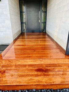 Polished hardwood entry deck with paver stepping stones