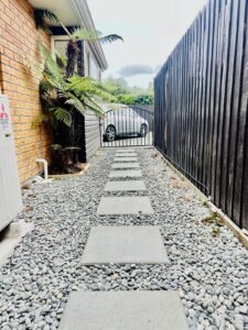 Paver stepping path along a side yard with gravel