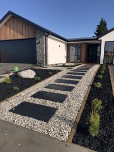 Concrete paver stepping path through a front garden