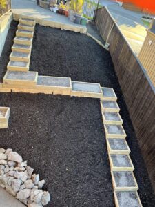 Timber retaining terrace steps with gravel treads