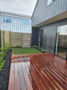 Hardwood deck, lawn and planting in a new-build rear yard
