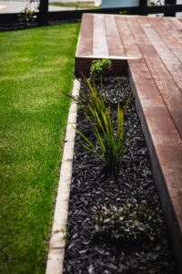 Hardwood deck beside a new lawn with planted edge